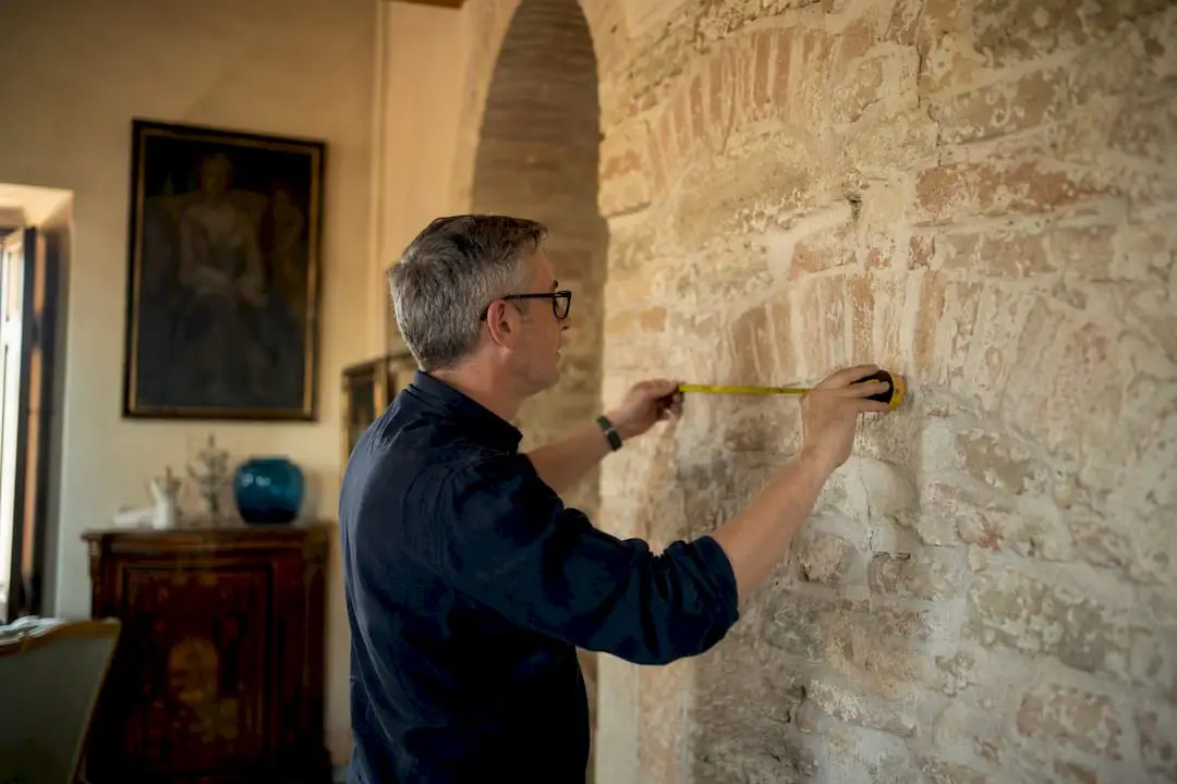 Engineer measuring load-bearing wall